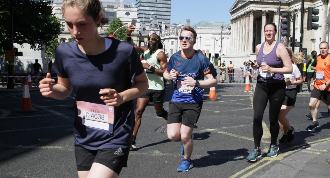 A picture of me (Luc Shelton) in between two other participants, running around the corner on the final kilometre of the ASICS London 10K. There is a guy to my right taking a picture of himself!