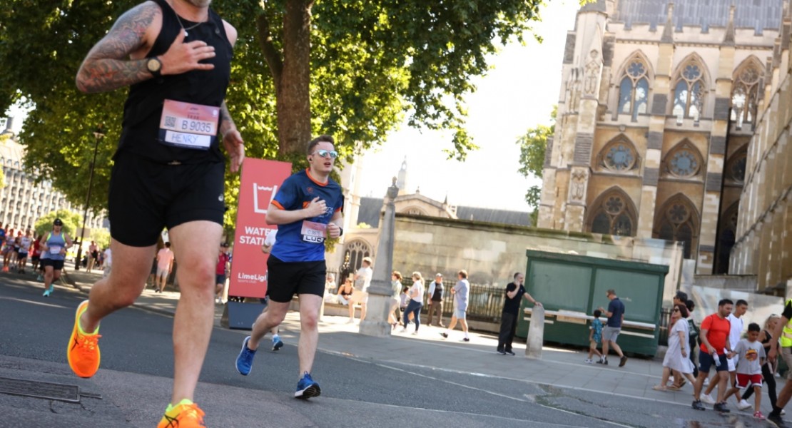 Another picture of myself (Luc Shelton) running past the Palace of Westminster. There is someone to my left. I am wearing a SpecialEffect athletic jersey.